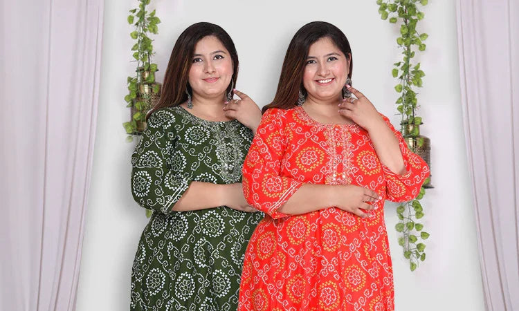 Plus size woman wearing green and red printed kurtas with three-quarter sleeves, standing against a neutral background with hanging plants